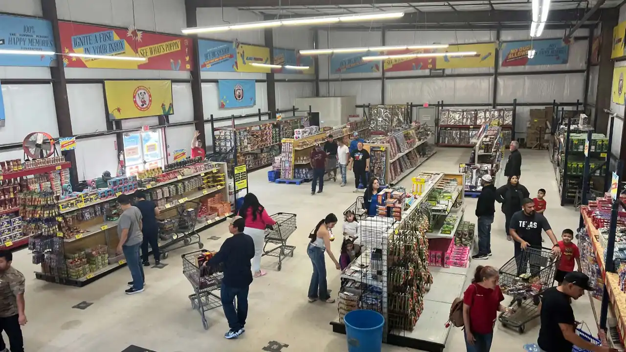 Shoppers browsing the aisles of an Alamo Fireworks store