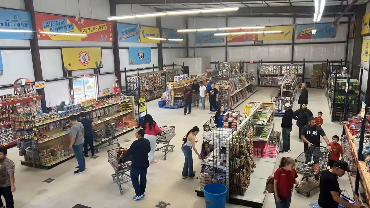 Shoppers browsing the aisles of an Alamo Fireworks store