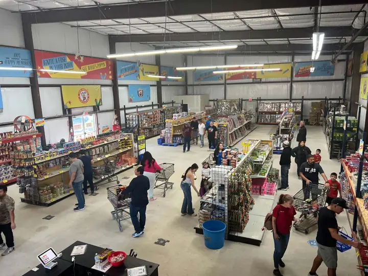 Shoppers browsing the aisles of an Alamo Fireworks store