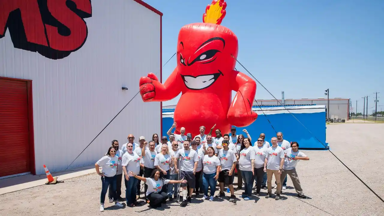 The Alamo Fireworks team posing with the giant inflatable Burst mascot